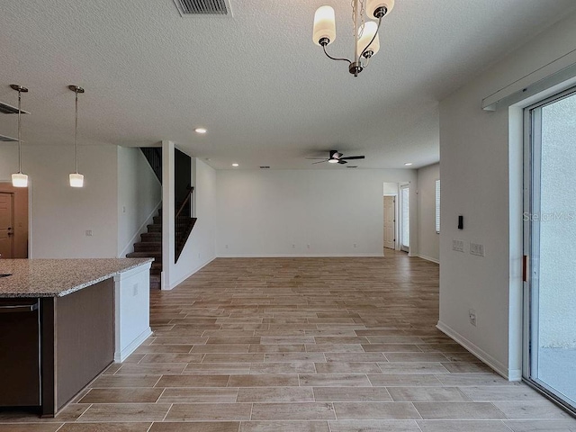 38120 Shale Stone Ct, Zephyrhills, FL 33540 - unfurnished living room with ceiling fan, a textured ceiling, stairway, light wood-type flooring, and recessed lighting
