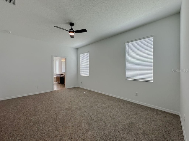 38120 Shale Stone Ct, Zephyrhills, FL 33540 - carpeted spare room with ceiling fan and a textured ceiling