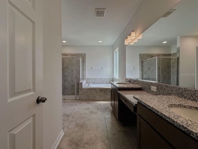 38120 Shale Stone Ct, Zephyrhills, FL 33540 - bathroom with two vanities, a stall shower, a bath, and tile patterned floors