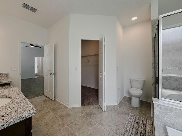 38120 Shale Stone Ct, Zephyrhills, FL 33540 - full bath with vanity, a walk in closet, tile patterned flooring, and a shower with door