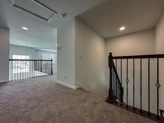 38120 Shale Stone Ct, Zephyrhills, FL 33540 - hallway featuring carpet flooring, recessed lighting, an upstairs landing, and a textured ceiling