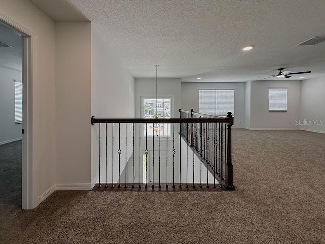 38120 Shale Stone Ct, Zephyrhills, FL 33540 - corridor featuring carpet flooring, a textured ceiling, a chandelier, an upstairs landing, and recessed lighting