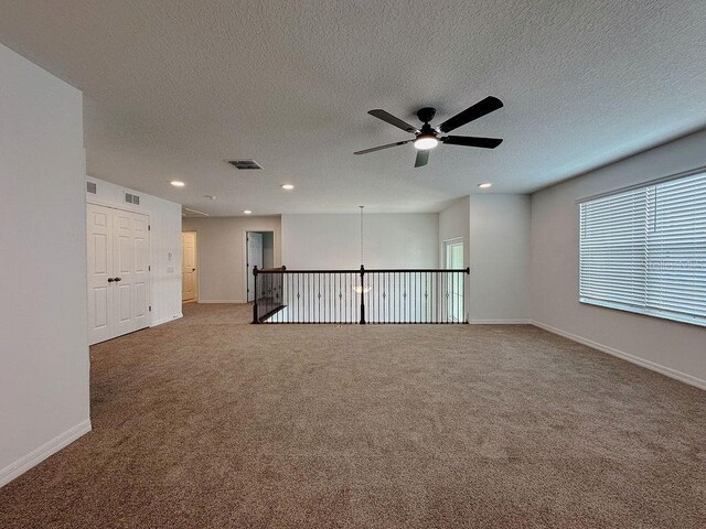 38120 Shale Stone Ct, Zephyrhills, FL 33540 - empty room featuring a ceiling fan, carpet floors, recessed lighting, and a textured ceiling