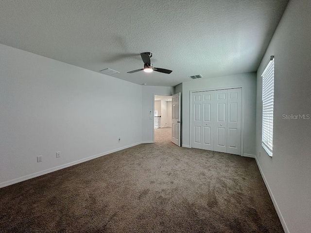 38120 Shale Stone Ct, Zephyrhills, FL 33540 - unfurnished bedroom with carpet, a textured ceiling, a closet, and ceiling fan