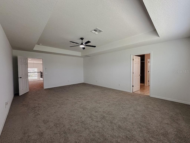 38120 Shale Stone Ct, Zephyrhills, FL 33540 - spare room with a raised ceiling, ceiling fan, a textured ceiling, and carpet