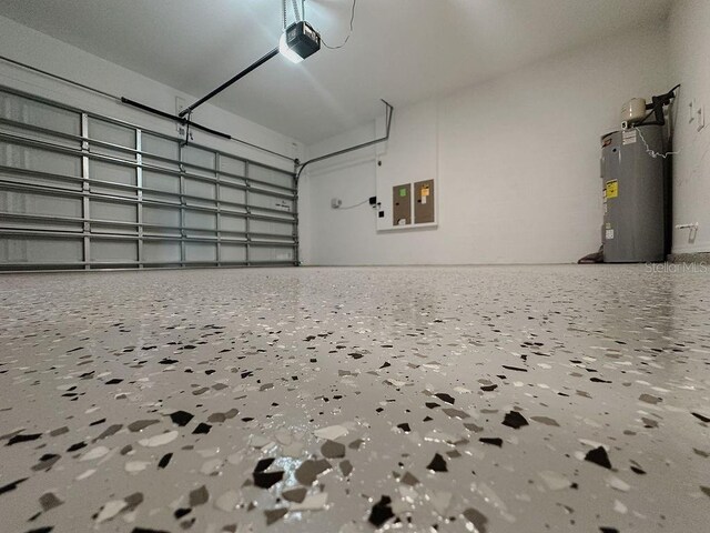 38120 Shale Stone Ct, Zephyrhills, FL 33540 - garage with water heater, a garage door opener, and electric panel