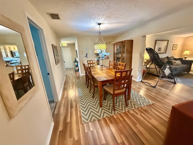 1814 Driftwood Cir S, Oldsmar, FL 34677 - dining space featuring wood finished floors and a textured ceiling