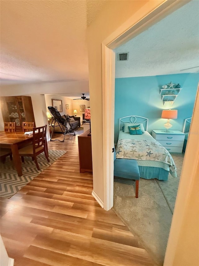 1814 Driftwood Cir S, Oldsmar, FL 34677 - bedroom featuring wood finished floors and a textured ceiling