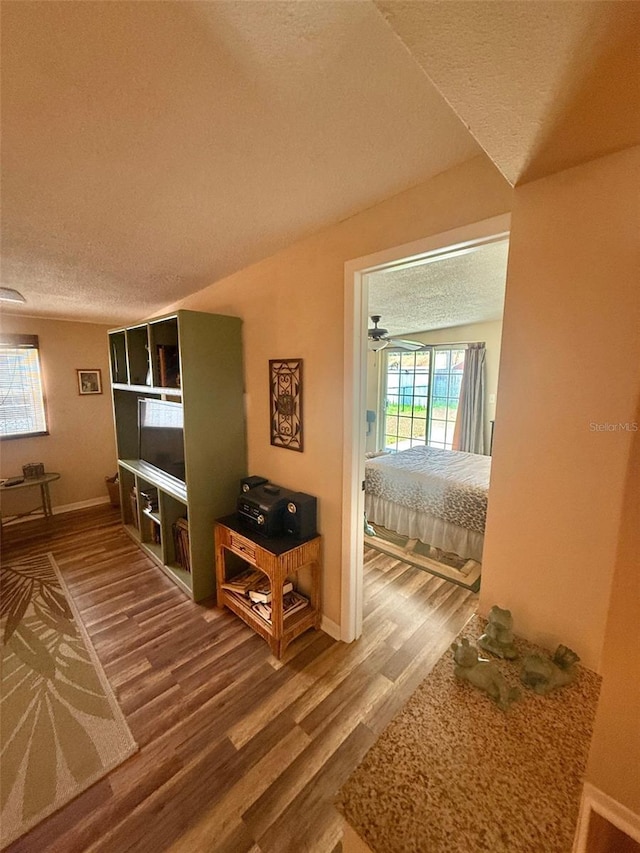 1814 Driftwood Cir S, Oldsmar, FL 34677 - corridor featuring a textured ceiling and wood finished floors