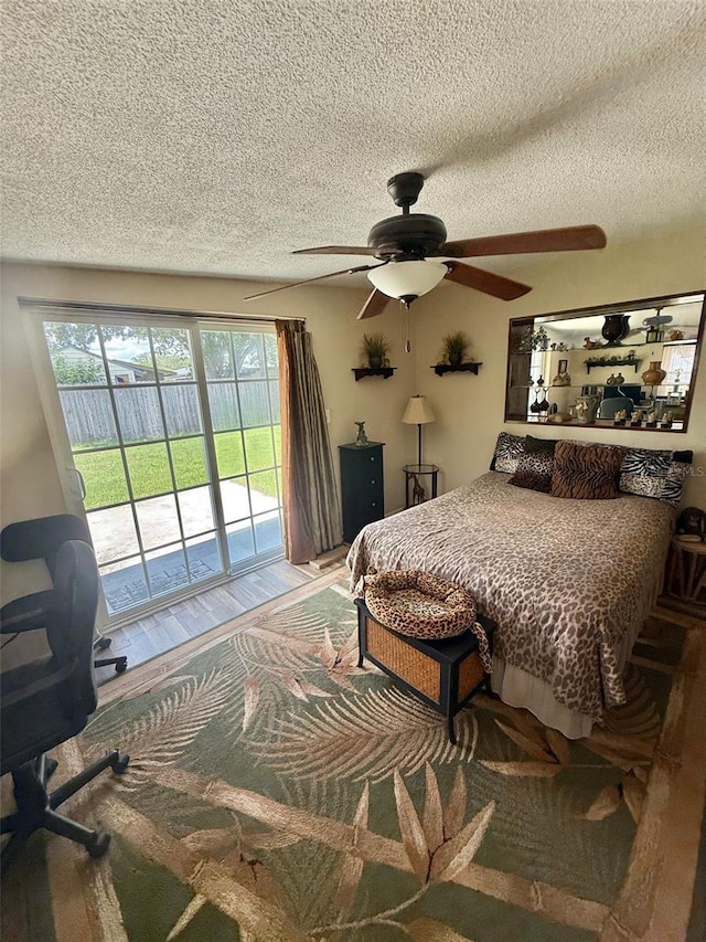 1814 Driftwood Cir S, Oldsmar, FL 34677 - bedroom with access to outside, a textured ceiling, wood finished floors, and ceiling fan