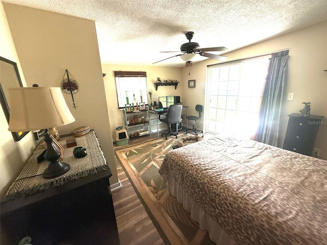 1814 Driftwood Cir S, Oldsmar, FL 34677 - bedroom featuring wood finished floors, an office area, a textured ceiling, and a ceiling fan