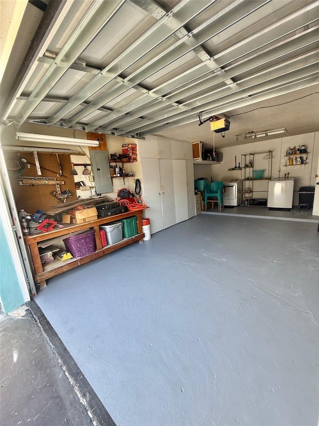 1814 Driftwood Cir S, Oldsmar, FL 34677 - garage featuring electric panel, washing machine and dryer, a garage door opener, and a workshop area