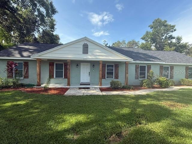 2005 Capri Rd, Valrico, FL 33594 - single story home with a front yard, brick siding, and covered porch