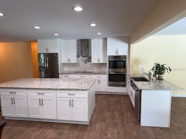 2005 Capri Rd, Valrico, FL 33594 - kitchen with stainless steel appliances, wall chimney exhaust hood, dark wood-style flooring, white cabinetry, and backsplash