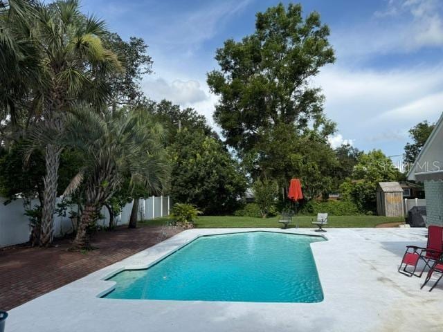 2005 Capri Rd, Valrico, FL 33594 - swimming pool with a shed, a fenced backyard, and a patio