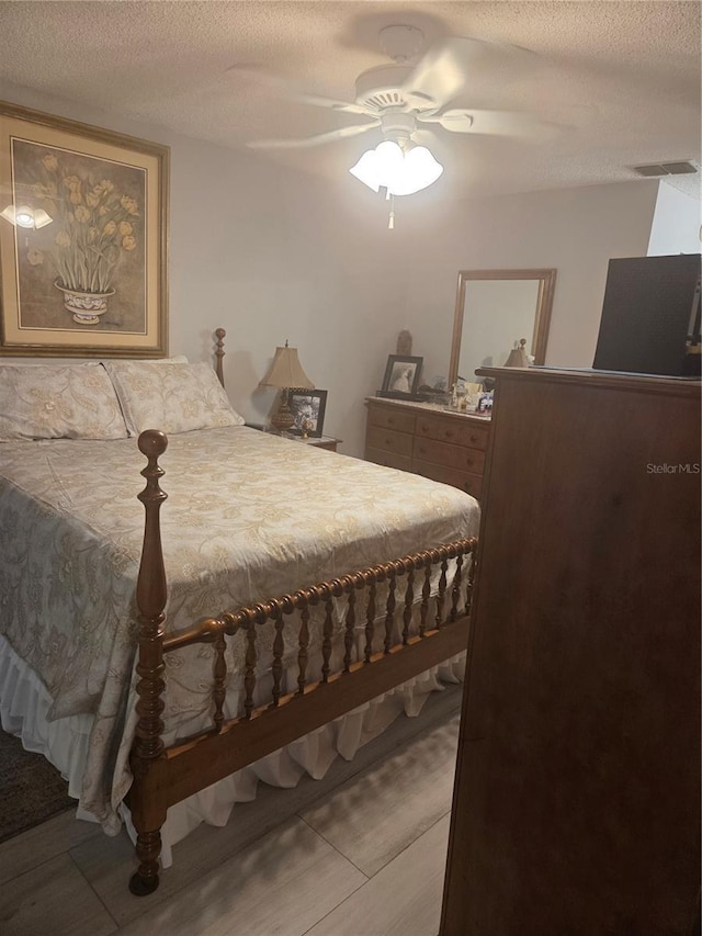 12133 Spartan Way Unit 203, Hudson, FL 34667 - bedroom with a ceiling fan and a textured ceiling