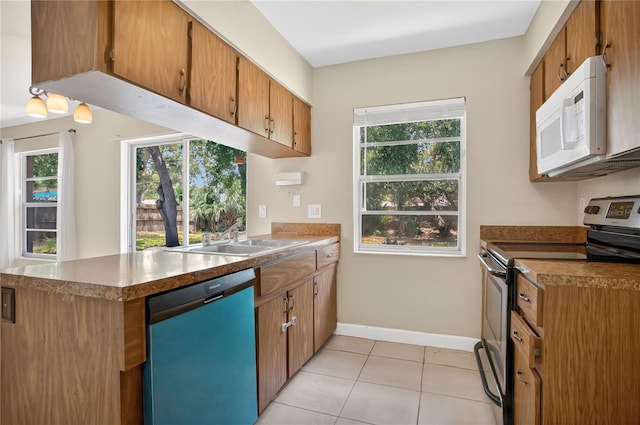 1600 Amberlea Dr N, Dunedin, FL 34698 - kitchen featuring stainless steel electric stove, dishwasher, white microwave, a peninsula, and light tile patterned floors