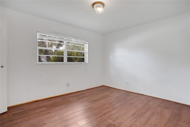 1600 Amberlea Dr N, Dunedin, FL 34698 - unfurnished room featuring wood finished floors and baseboards