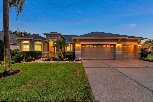 31646 Baymont Loop, Wesley Chapel, FL 33543 - view of front facade with stucco siding, an attached garage, concrete driveway, and a front yard