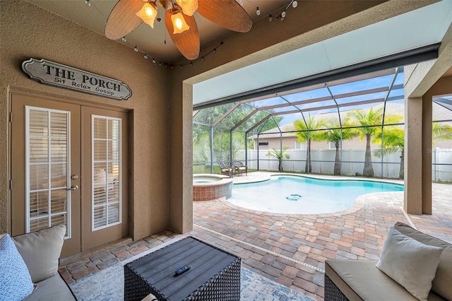 31646 Baymont Loop, Wesley Chapel, FL 33543 - view of swimming pool featuring a fenced backyard, a patio area, a pool with connected hot tub, a ceiling fan, and french doors