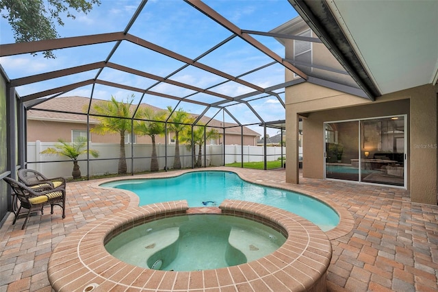 31646 Baymont Loop, Wesley Chapel, FL 33543 - view of swimming pool featuring a patio, a pool with connected hot tub, a fenced backyard, and a lanai