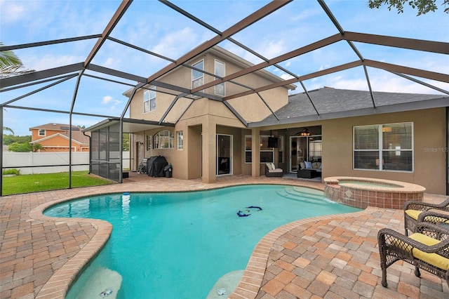 31646 Baymont Loop, Wesley Chapel, FL 33543 - view of swimming pool with a patio area, a ceiling fan, a pool with connected hot tub, and glass enclosure