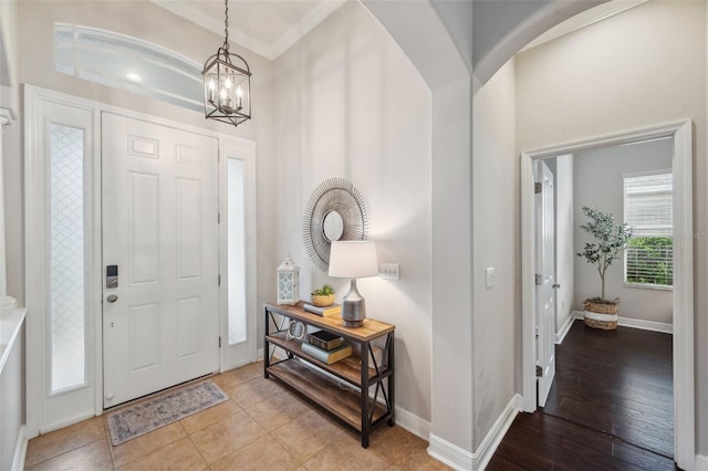 31646 Baymont Loop, Wesley Chapel, FL 33543 - entrance foyer featuring crown molding, a chandelier, and arched walkways