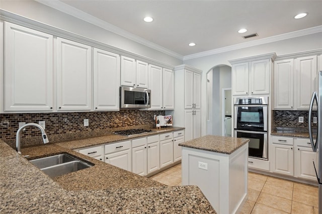 31646 Baymont Loop, Wesley Chapel, FL 33543 - kitchen featuring appliances with stainless steel finishes, backsplash, light tile patterned flooring, white cabinetry, and recessed lighting