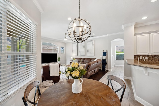 31646 Baymont Loop, Wesley Chapel, FL 33543 - dining room with arched walkways, inlaid floor details, light tile patterned floors, recessed lighting, and a chandelier