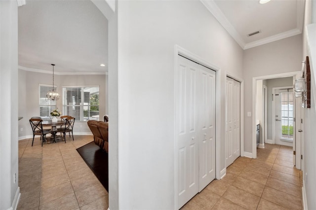 31646 Baymont Loop, Wesley Chapel, FL 33543 - hall featuring light tile patterned floors, crown molding, recessed lighting, a chandelier, and arched walkways