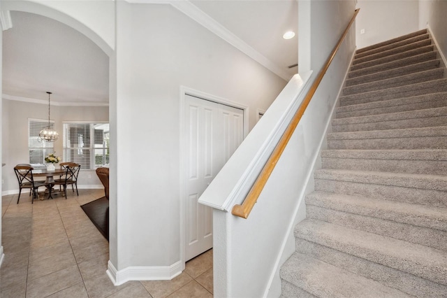 31646 Baymont Loop, Wesley Chapel, FL 33543 - stairs featuring tile patterned floors, arched walkways, recessed lighting, a chandelier, and crown molding