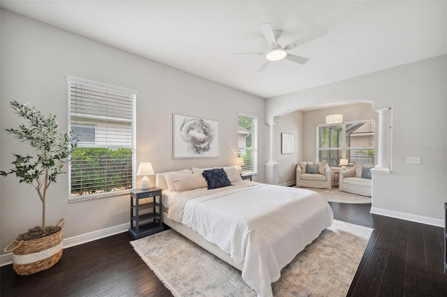 31646 Baymont Loop, Wesley Chapel, FL 33543 - bedroom with decorative columns, arched walkways, dark wood-style floors, and a ceiling fan