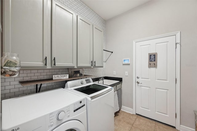 31646 Baymont Loop, Wesley Chapel, FL 33543 - washroom featuring washing machine and clothes dryer, cabinet space, and light tile patterned flooring