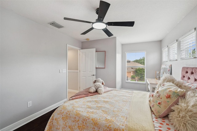 31646 Baymont Loop, Wesley Chapel, FL 33543 - bedroom featuring dark wood-style floors and ceiling fan