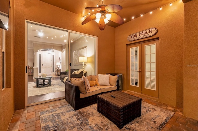 31646 Baymont Loop, Wesley Chapel, FL 33543 - living room featuring arched walkways, a ceiling fan, a textured wall, and stone tile floors