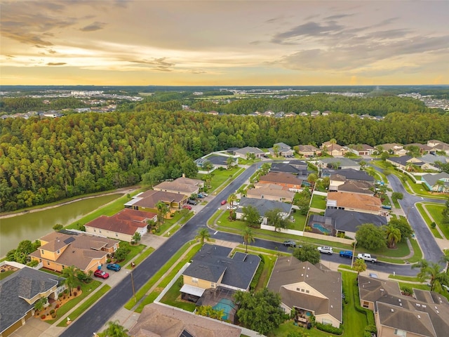 31646 Baymont Loop, Wesley Chapel, FL 33543 - aerial view at dusk of a residential view, a water view, and a wooded view