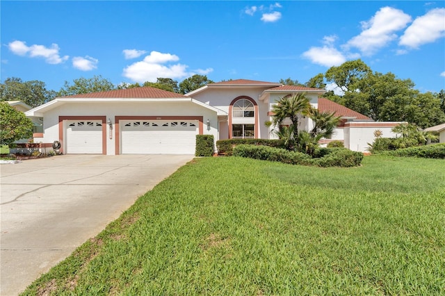18561 Winding Oaks Blvd, Hudson, FL 34667 - mediterranean / spanish-style home featuring a garage, stucco siding, a front yard, driveway, and a tiled roof