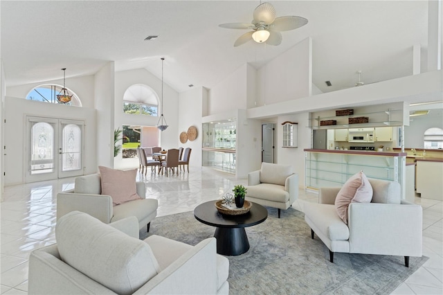 18561 Winding Oaks Blvd, Hudson, FL 34667 - living area featuring high vaulted ceiling, ceiling fan, light tile patterned flooring, and french doors