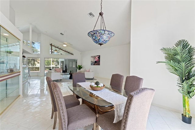18561 Winding Oaks Blvd, Hudson, FL 34667 - dining room with high vaulted ceiling, ceiling fan, and light tile patterned flooring
