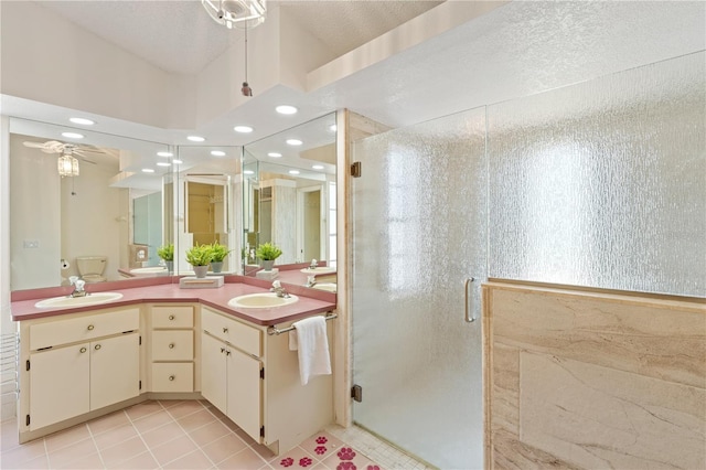 18561 Winding Oaks Blvd, Hudson, FL 34667 - full bathroom featuring a stall shower, ceiling fan, double vanity, tile patterned floors, and recessed lighting