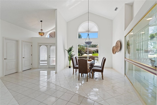 18561 Winding Oaks Blvd, Hudson, FL 34667 - dining space featuring high vaulted ceiling, french doors, and light tile patterned floors