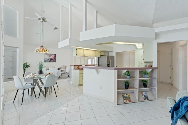 18561 Winding Oaks Blvd, Hudson, FL 34667 - kitchen featuring stainless steel fridge with ice dispenser, high vaulted ceiling, a ceiling fan, open shelves, and a textured ceiling