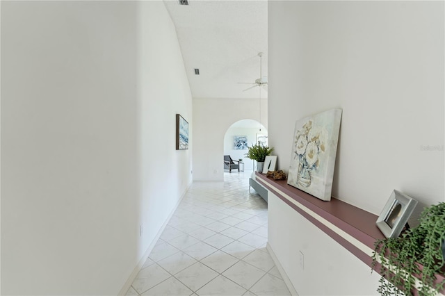 18561 Winding Oaks Blvd, Hudson, FL 34667 - corridor featuring arched walkways, a high ceiling, and light tile patterned floors
