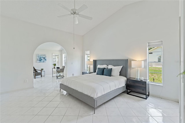 18561 Winding Oaks Blvd, Hudson, FL 34667 - bedroom featuring arched walkways, high vaulted ceiling, light tile patterned flooring, and ceiling fan
