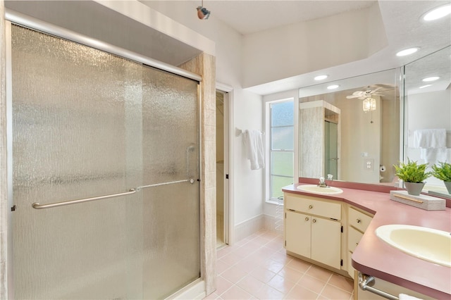 18561 Winding Oaks Blvd, Hudson, FL 34667 - bathroom with double vanity, a shower stall, tile patterned floors, recessed lighting, and a ceiling fan