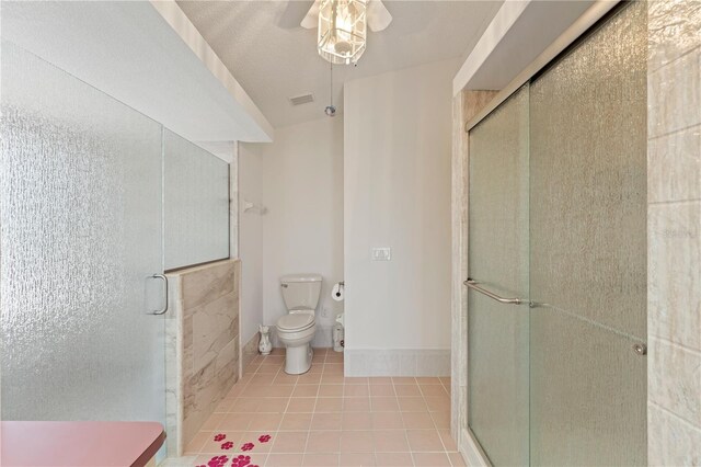 18561 Winding Oaks Blvd, Hudson, FL 34667 - full bath featuring a ceiling fan, a shower stall, and tile patterned floors