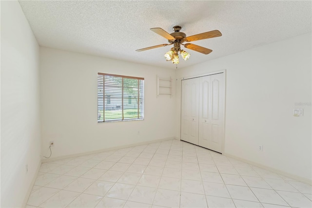 18561 Winding Oaks Blvd, Hudson, FL 34667 - unfurnished bedroom featuring a textured ceiling, a closet, and a ceiling fan