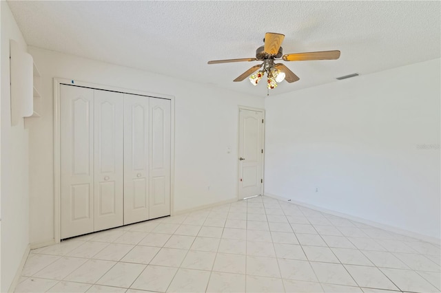 18561 Winding Oaks Blvd, Hudson, FL 34667 - unfurnished bedroom with ceiling fan, a textured ceiling, and a closet