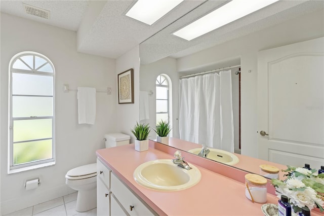 18561 Winding Oaks Blvd, Hudson, FL 34667 - full bathroom featuring tile patterned flooring, vanity, a textured ceiling, and curtained shower