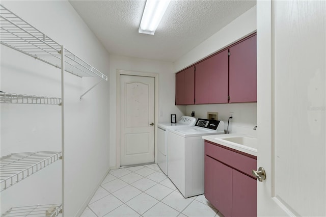 18561 Winding Oaks Blvd, Hudson, FL 34667 - washroom with cabinet space, independent washer and dryer, a textured ceiling, and light tile patterned flooring